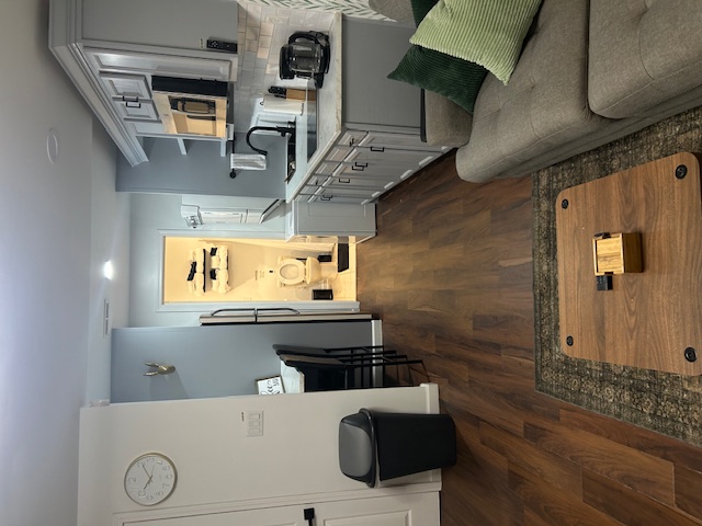 Clean open living room and kitchen with spotless floors and counters